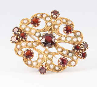 A 9ct yellow gold garnet and seed pearl brooch 5.4 grams, 30mm 