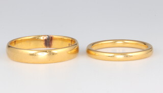 Two 22ct yellow gold wedding bands 7.4 grams, size J 1/2 and Q 