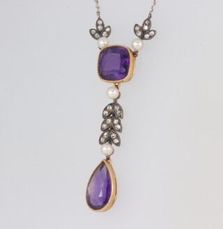 An Edwardian yellow metal amethyst, diamond and seed pearl pendant on a white metal necklace, the pendant 40mm, the chain 40cm, contained in original fitted box 