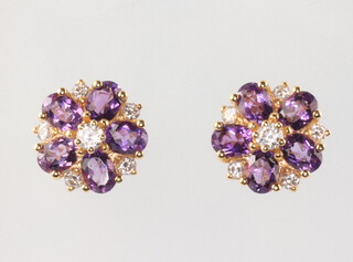 A pair of yellow metal stamped 18ct amethyst and diamond cluster ear studs 10mm,  5 grams 