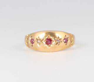 A Victorian 18ct yellow gold ruby and diamond gypsy set ring comprising 3 rubies and 2 diamonds, 0.12ct of rubies and 0.01ct of diamonds, 2.6 grams, size O 1/2 