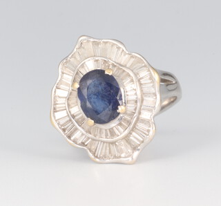 A white metal Art Deco style tapered baguette cut diamond and sapphire cluster ring approx. 1ct, the oval sapphire approx. 1ct chip), size I 1/2, 6.4 grams  