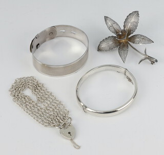 A silver bracelet, 2 bangles and a brooch, 63 grams