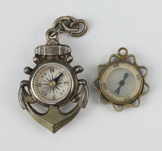 An Edwardian silver coloured fob in the form of an anchor compass, 1 other 