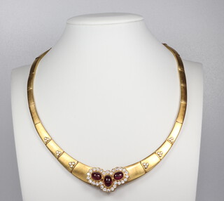 A fine yellow metal 750 graduated brushed articulated necklace set with 3 cabochon cut rubies, each approx 1ct surrounded by 28 brilliant cut diamonds, each approx. 0.03ct, the links set with 18 brilliant cut diamonds each approx. 0.01ct, 54.7 grams, 40cm 