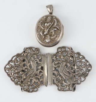 An Indian repousse white metal locket together with a pierced buckle decorated with birds, 69 grams 