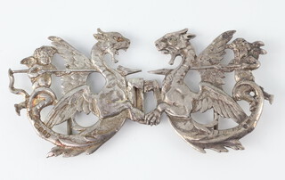 A Victorian silver cast buckle in the form of cherubs riding dragons, London 1897 import marks, 34.4 grams 