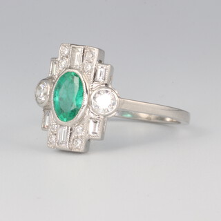 A white metal plat. emerald and diamond ring, the centre stone 1.1ct and the brilliant cut diamonds 0.9ct, 4.7 grams, size P 