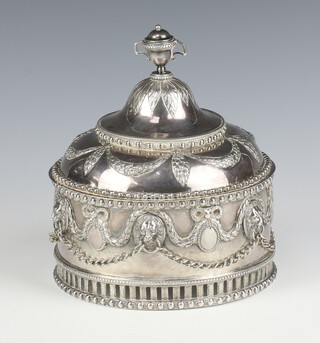 An impressive 19th Century  Continental white metal circular silver box and cover with trophy cup finial and repousse swags with lion ring masks supporting chains on a pierced base 946 grams, 14cm 