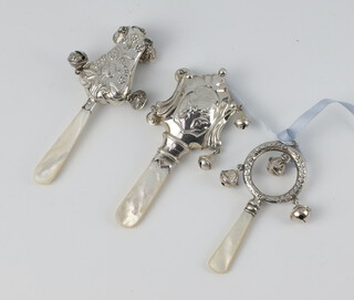 An Edwardian repousse silver rattle Birmingham 1907, a ditto Birmingham 1914 and 1 other 