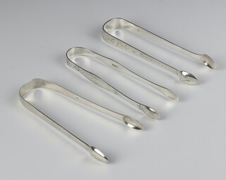 A pair of George III silver sugar tongs/nips Newcastle 1817 and 2 other pairs, 96 grams