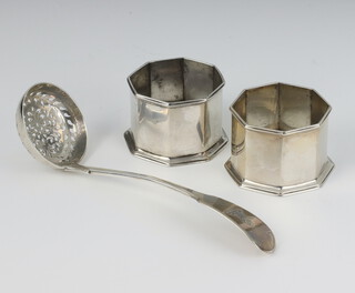 A pair of Edwardian octagonal silver mustard holders London 1908 and a Victorian silver sifter spoon, London 1840, 140 grams 