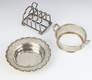 A circular silver dish with scallop decoration Sheffield 1932, toast rack Sheffield 1918 and a pierced stand Birmingham 1929, 282 grams gross 