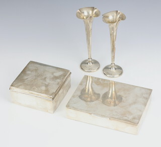 A silver cigarette box Birmingham 1924, 9.5cm, a pair of silver spill vases 13cm and a plated cigarette box 