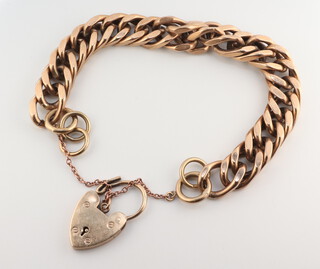 A 9ct yellow gold flat link bracelet with heart padlock, 58.4 grams, 18cm  