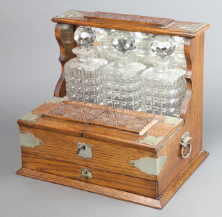 An Edwardian silver plated mounted 3 bottle tantalus with base drawer 