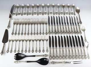 A set of Sterling silver Eloquence cutlery by Lunt with Rococo handles comprising 12 dinner forks, 12 dessert forks, 24 dessert spoons, 2 serving spoons, serving fork, 2468 grams together with 12 silver handled dinner knives, 12 silver handled steak knives, pair of silver handle salad servers, silver handled cake slice and a silver handle pair of carving knife and fork 