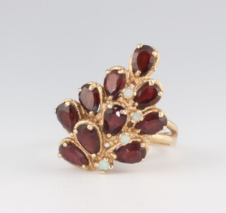 A yellow metal 14k garnet and opal dress ring 7.7 grams, size O 