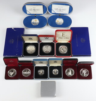 Two 1986 proof silver one dollar crowns and 12 other commemorative silver crowns, 331 grams 