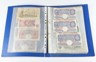 An album of world bank notes including 2 five pound notes E46061957 and W18001856 1944 and 1951, a quantity of others 