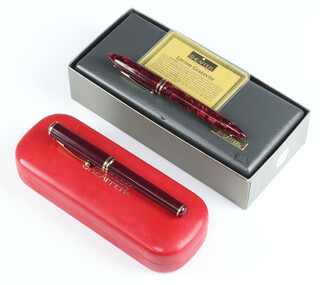 A Sheaffer Connaisseur red fountain pen with 18ct nib with a ditto marbled ballpoint pen, both boxed 