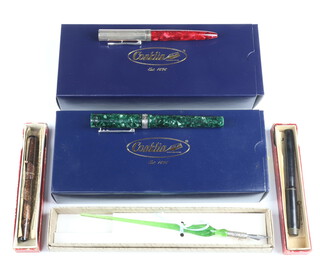 A Conklin Duragraph green marbled fountain pen, a Coronet pink marbled and gilt ditto, both boxed, 2 other pens and a green glass handled fountain nib 