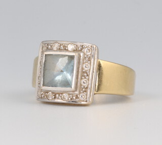 A yellow metal square aquamarine and diamond cocktail ring, the centre stone approx. 1ct, surrounded by brilliant cut diamonds, size K 4.4 grams 