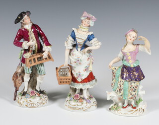 A pair of 20th Century Sitzendorf figures of street sellers raised on rococo bases 17cm, ditto figure of a girl with lamb 15cm (all have minor chips) 