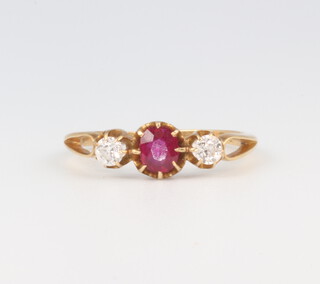 A yellow metal ruby and diamond ring, the centre stone 0.25ct, the 2 diamonds 0.10ct each, 1.8 grams, size K 1/2