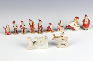 A collection of Victorian bisque Christmas cake decorations comprising 9 figures, a reindeer and 2 children on a roof 