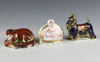 A Royal Crown Derby Imari pattern  paperweight - Scottish Terrier 11cm, ditto otter 5cm and Crown name stand 8m, all boxed and all with gold stoppers 