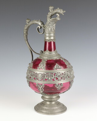 A 19th Century  Continental cranberry glass ewer with pewter mounts decorated with figures 33cm 