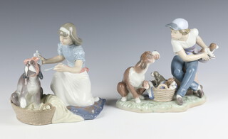 A Lladro group of a boy with dog 5376 17cm, ditto girl feeding a dog 5921 15cm 