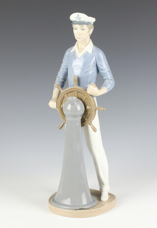 A Lladro figure of a sailor standing at a ships wheel 5206 33cm 