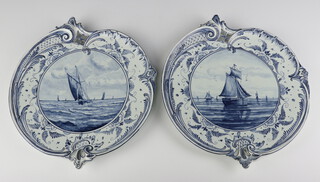 A pair of Royal Bonn Delft shell shaped wall plaques decorated with boats 1193 34cm 