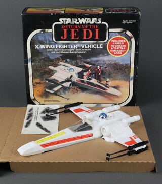 Star Wars by Palitoy, an X Wing Fighter Vehicle with "Battle Damaged" look feature, in Return of The Jedi box, still attached to the original card insert with instructions and used battle damaged decal sticker sheet ( France 1983 )  