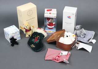 Steiff, a collection of teddy bears to include limited edition Crystal Bear bag pendant no.1074 of 3500 11cm boxed and with certificate, ditto Keyring Bear 10cm no.604 of 2000 with certificate and striped bag, Felt Bear 17cm no.269 of 2000 with certificate and striped bag, Lotte Bear contained in a small suitcase (no certificate), Winnie the Pooh 19cm part boxed (no certificate), Paddington Bear 11cm boxed (no certificate), 2005 Stocking and Bear (no certificate), Roly Poly Santa Bear 12cm no.206 of 5000 boxed and with certificate, all contained in a red plastic box  