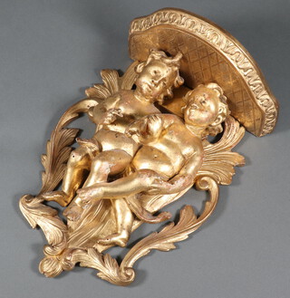 A 19th Century carved wooden and gilt painted wall bracket supported by 2 cherubs  30cm h x 21cm w x 14cm d 