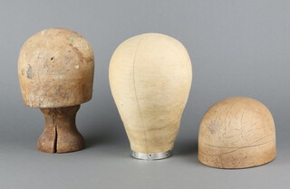 A wooden hat block, the base marked 53 11cm h x 19cm w x 15cm d, 1 other with unmarked base on turned wooden stand (split to stand), a fabric mannequin head 26cm x 16cm and a turned wooden hat stand 24cm 