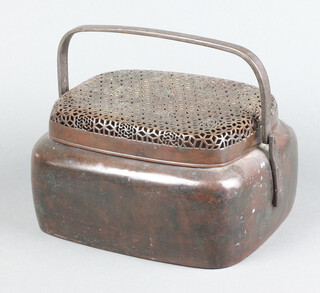 A curious rectangular Eastern bronze box with pierced grilled top and swing handle 14cm x 24cm x 22cm (some dents)