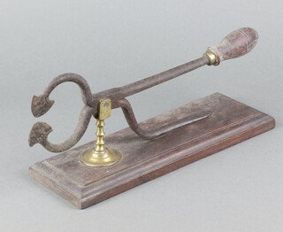 A pair of 19th Century iron sugar cutters with brass column raised on a rectangular mahogany base 15cm h x 29cm w x 10cm d 