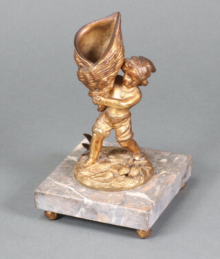 A 19th Century gilt metal match striker in the form of a standing boy with shell raised on a pink veined marble base 17cm h x 10cm w x 10cm d 