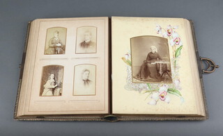 A Victorian leather bound photograph album, containing approximately 60 black and white photographs  