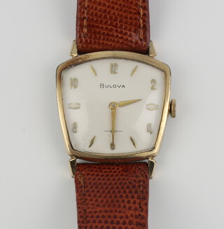 A gentleman's gilt cased Bulova wristwatch of wedge shaped form, the case numbered E692120 contained in a 30mm case on a leather bracelet 