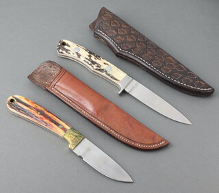 A Howard Hitchmough hunting knife with 9cm blade, horn grip and leather scabbard together with an RR Middleton hunting knife with 8 cm blade, horn grip, leather scabbard 