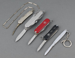 Victorinox a Swiss Army knife with black grip marked Flo-Eda and 1 other with red grip 6cm, an unmarked multi bladed pocket knife, ditto twin bladed and ditto single bladed 