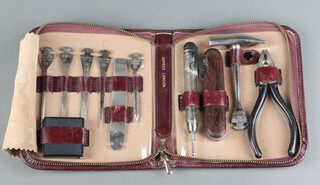 Dreizack for Asprey, a 7 piece hand tool kit together with pliers and tape measure contained in a red leather case 