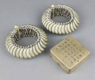 A pair of Eastern shackle bracelets together with a Chinese square metal box the lid with script decoration 3cm x 7cm x 7cm 