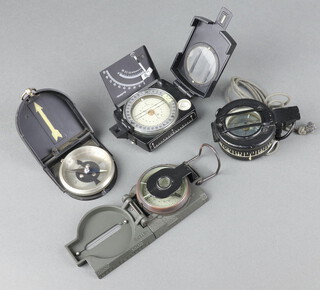 A military issue prismatic compass the base marked G.E.C. no. B 138618 and 3 other compasses