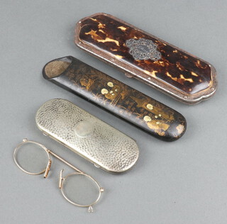 An oval planished metal spectacle case containing a pair of pince nez, a 19th Century rectangular black lacquered chinoiserie style case and a tortoiseshell effect and polished steel double spectacle case 